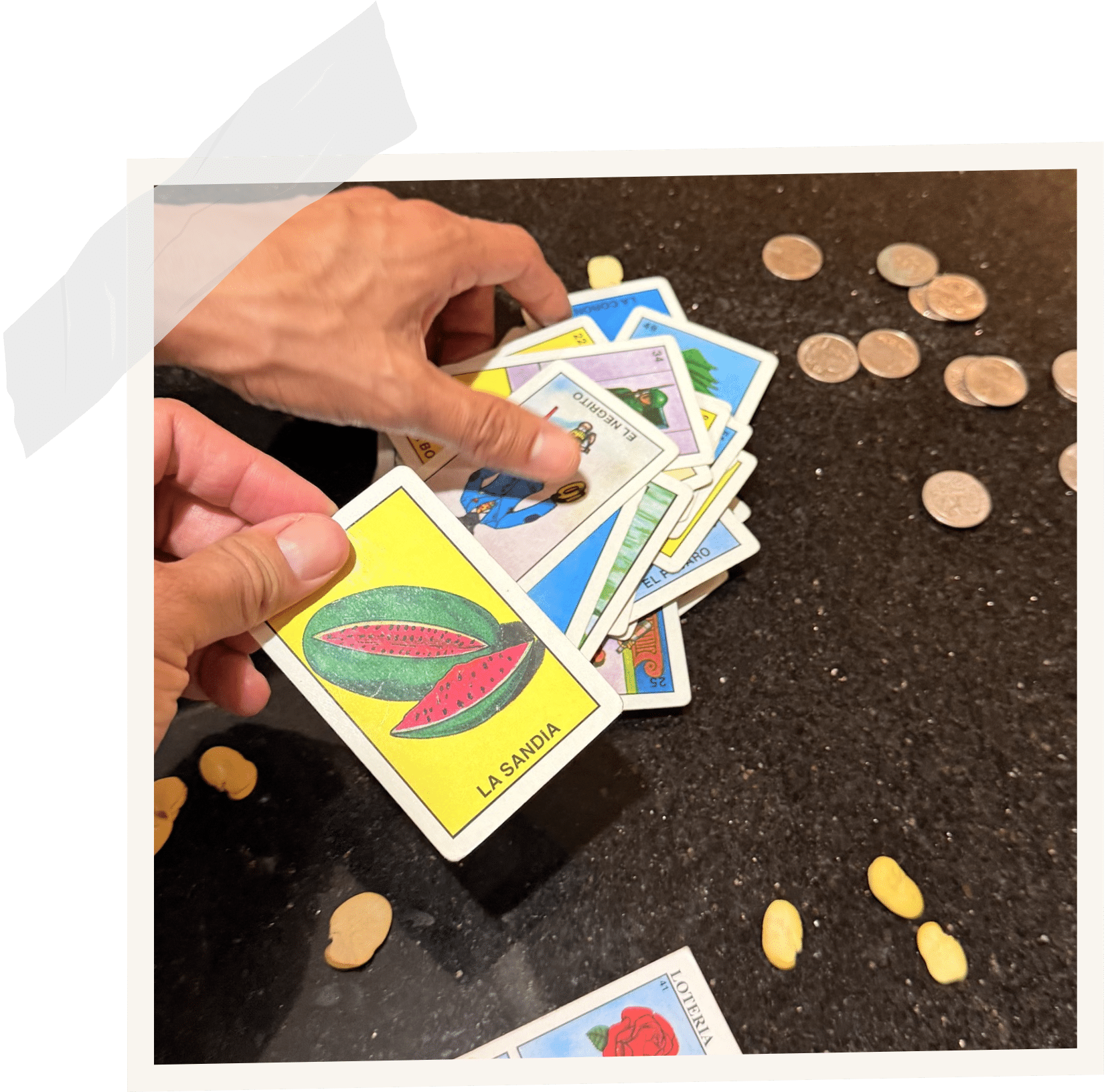 Hands playing traditional Mexican lotería cards, part of Andreina Zamudio's story as a culturally rooted therapist