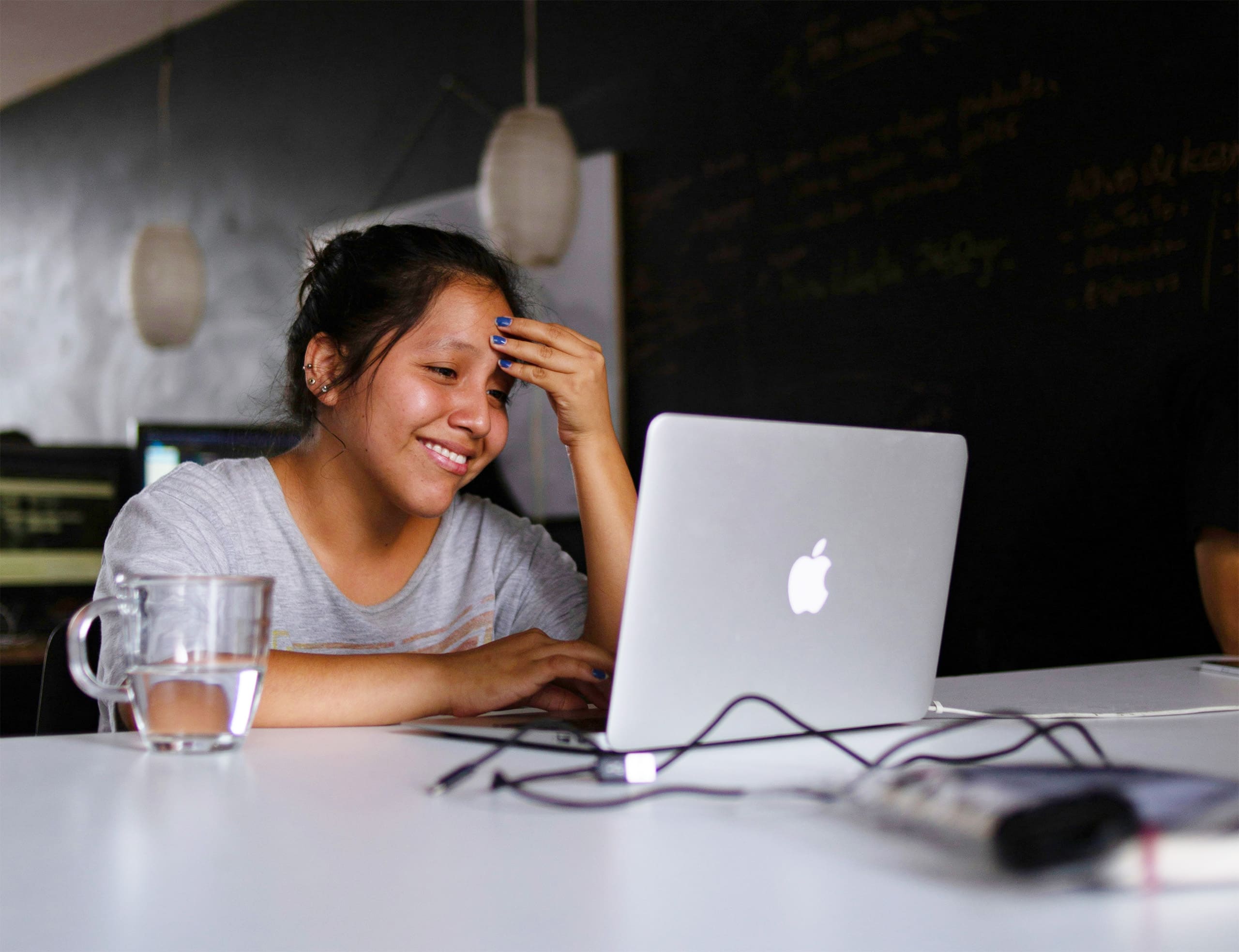 Student working on a laptop, reflecting Andreina Zamudio's mentorship program for BIPOC students in human services
