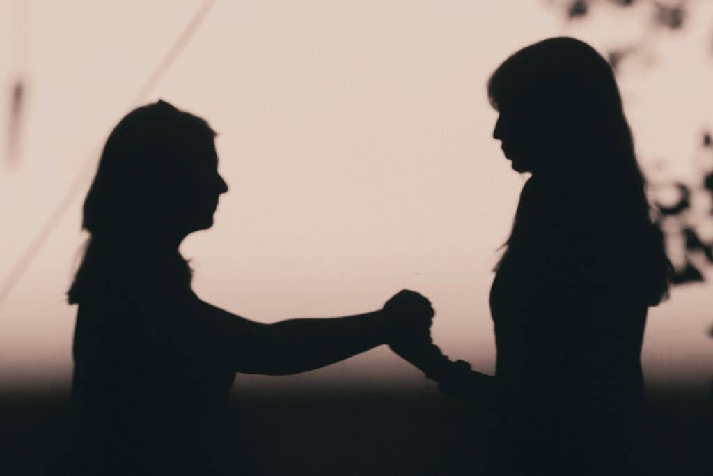 Two people having a meaningful conversation outdoors
